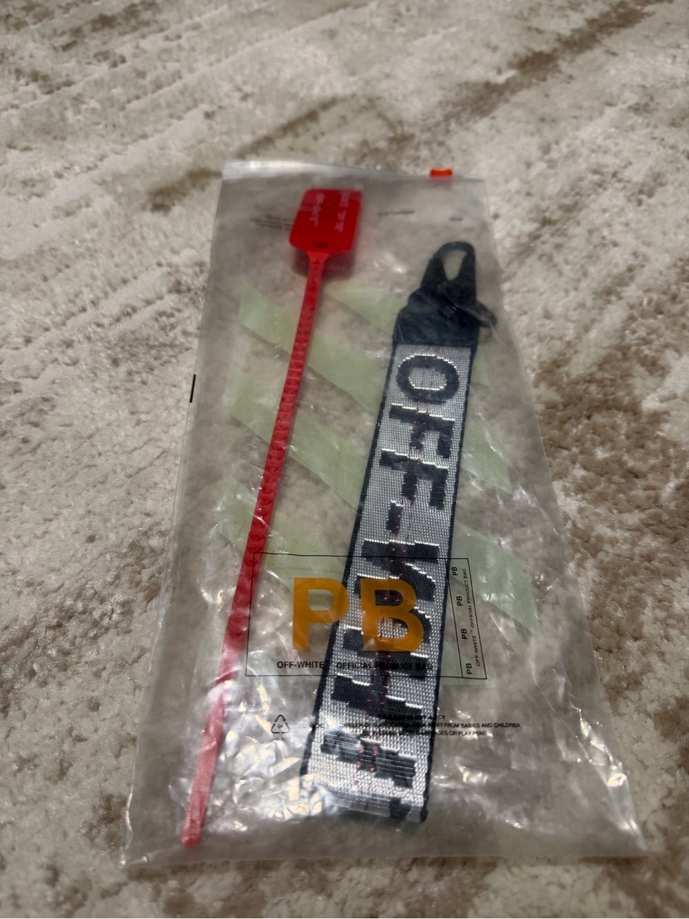 Off-White Black and White Branded Strap Keyring with Red Zip Tie Accent